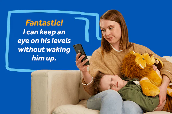 CareLink™ Connect app for the MiniMed™ 770G system Image of a mom checking her sleeping son’s sugar levels on her smartphone